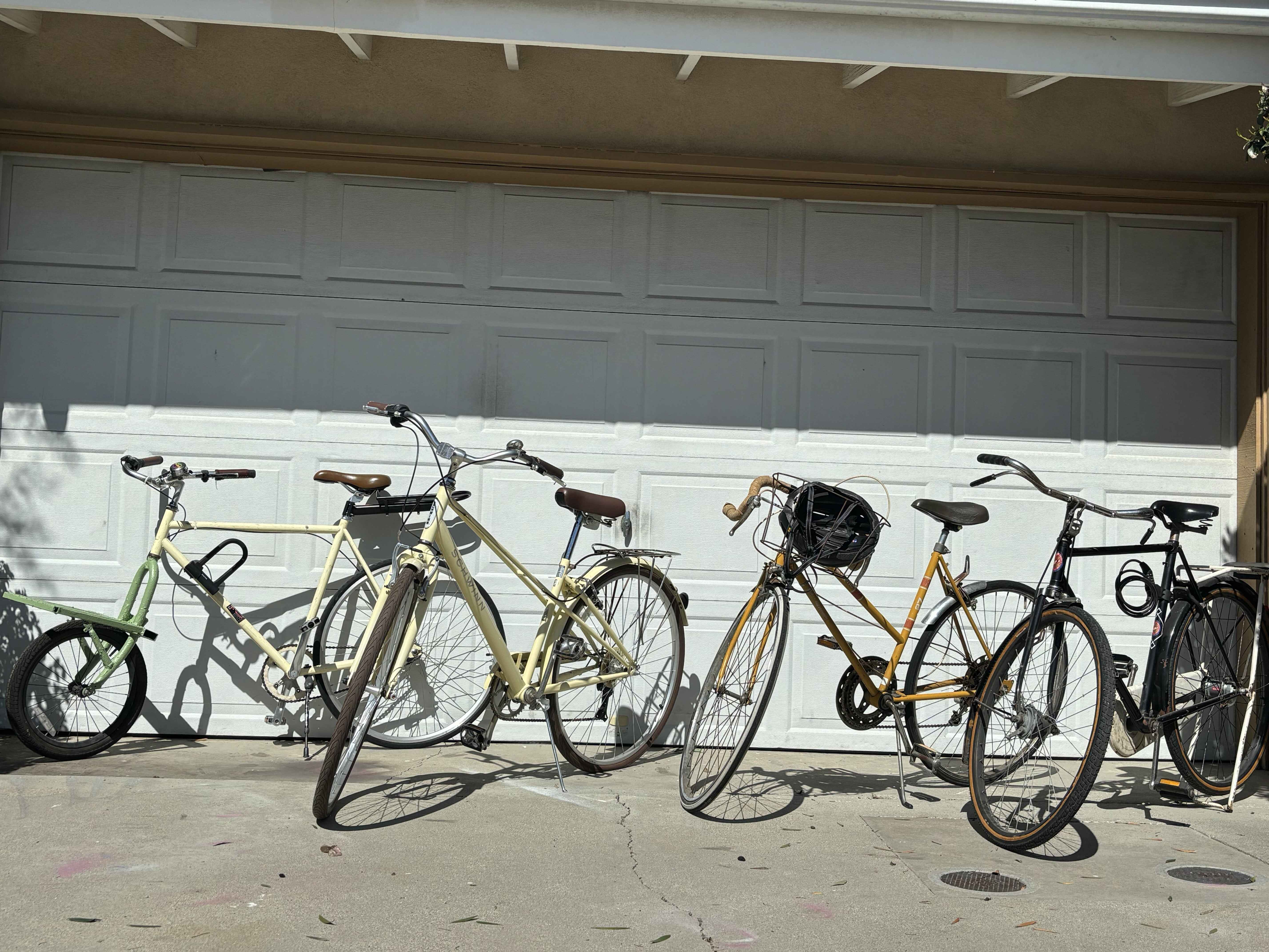 four bikes in front of a garage door