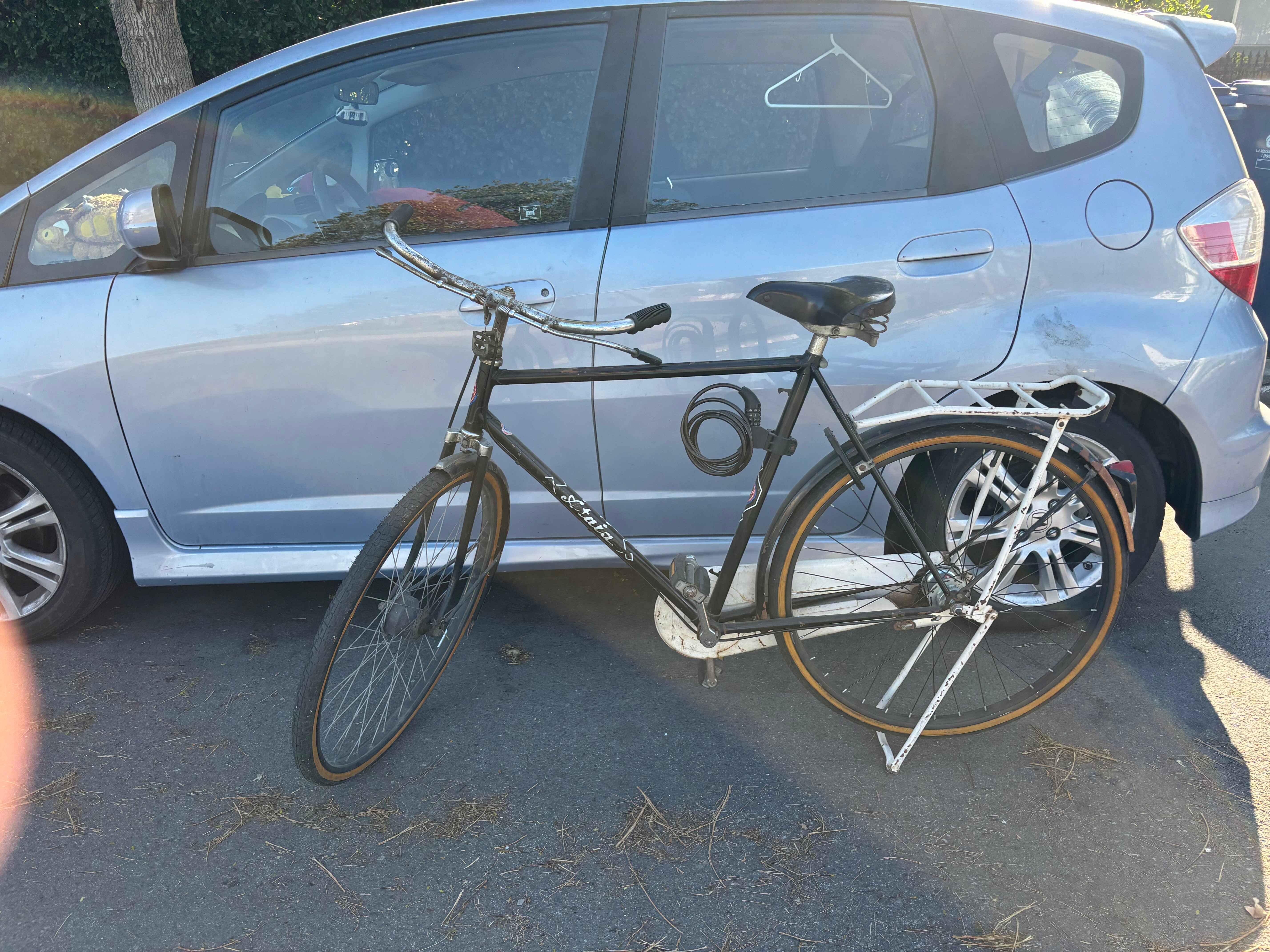 bike sitting next to car