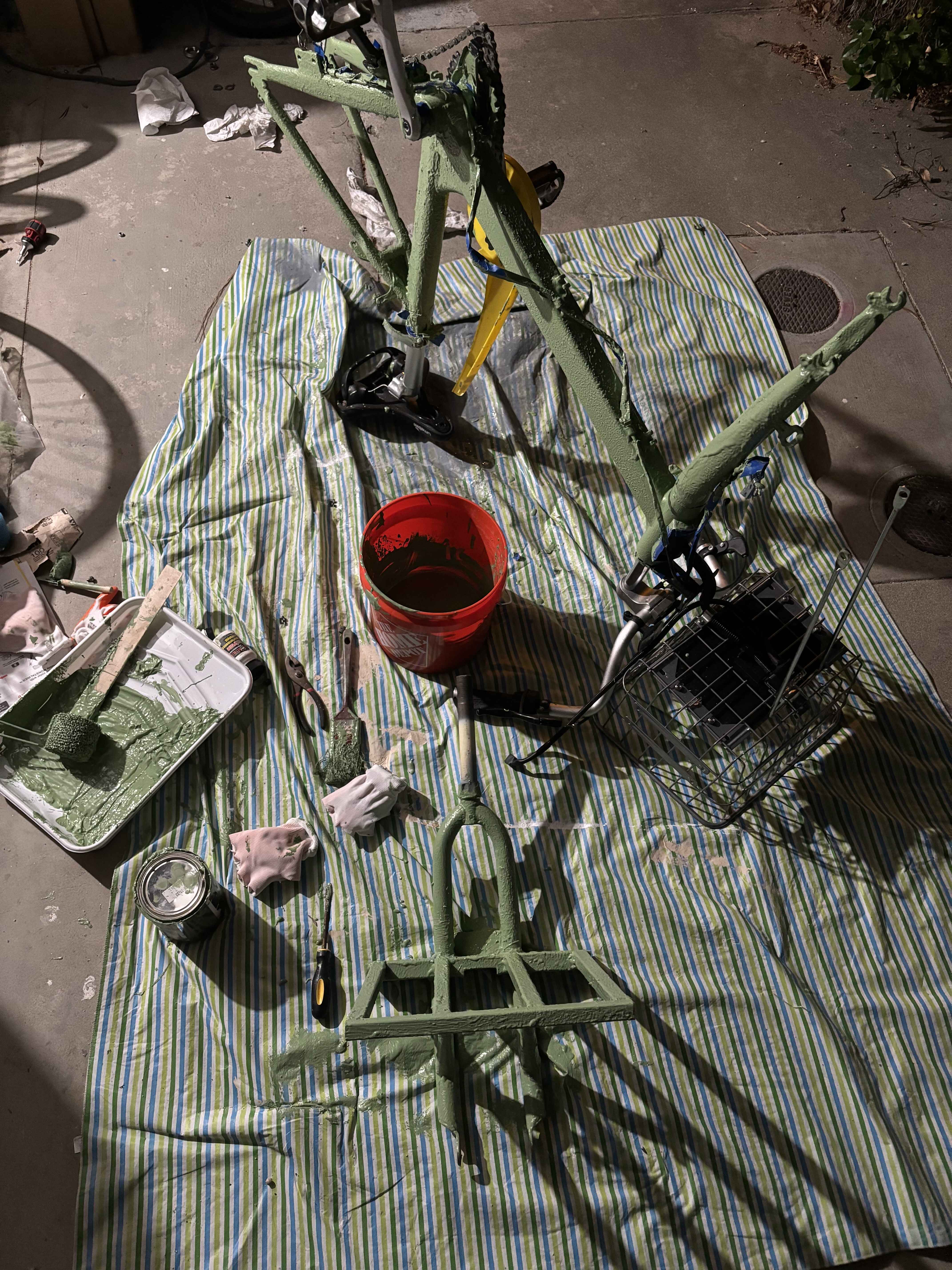 bike frame on a tarp covered in a gooey coating