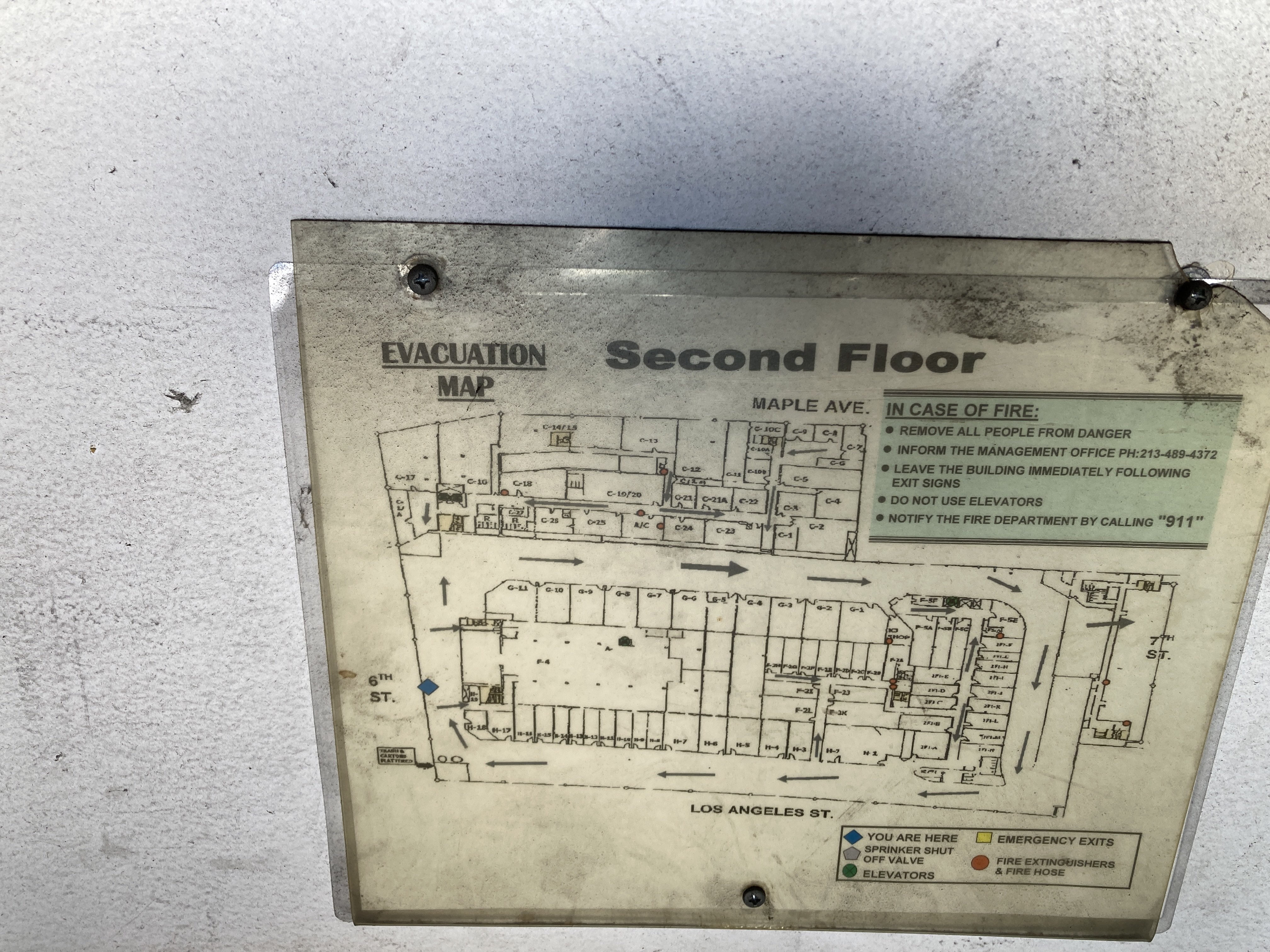 printed evacuation map of the second floor of the building. there is a large loop for truck traffic, with many small internal rooms in the middle of it.
