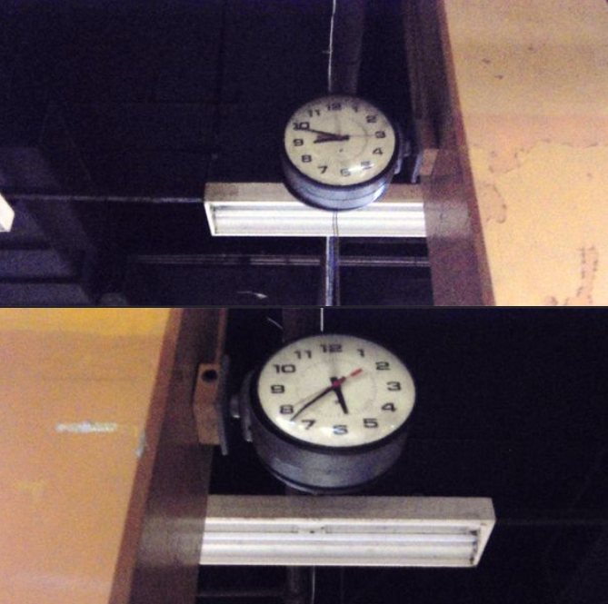 two analog clocks mounted on pillars.