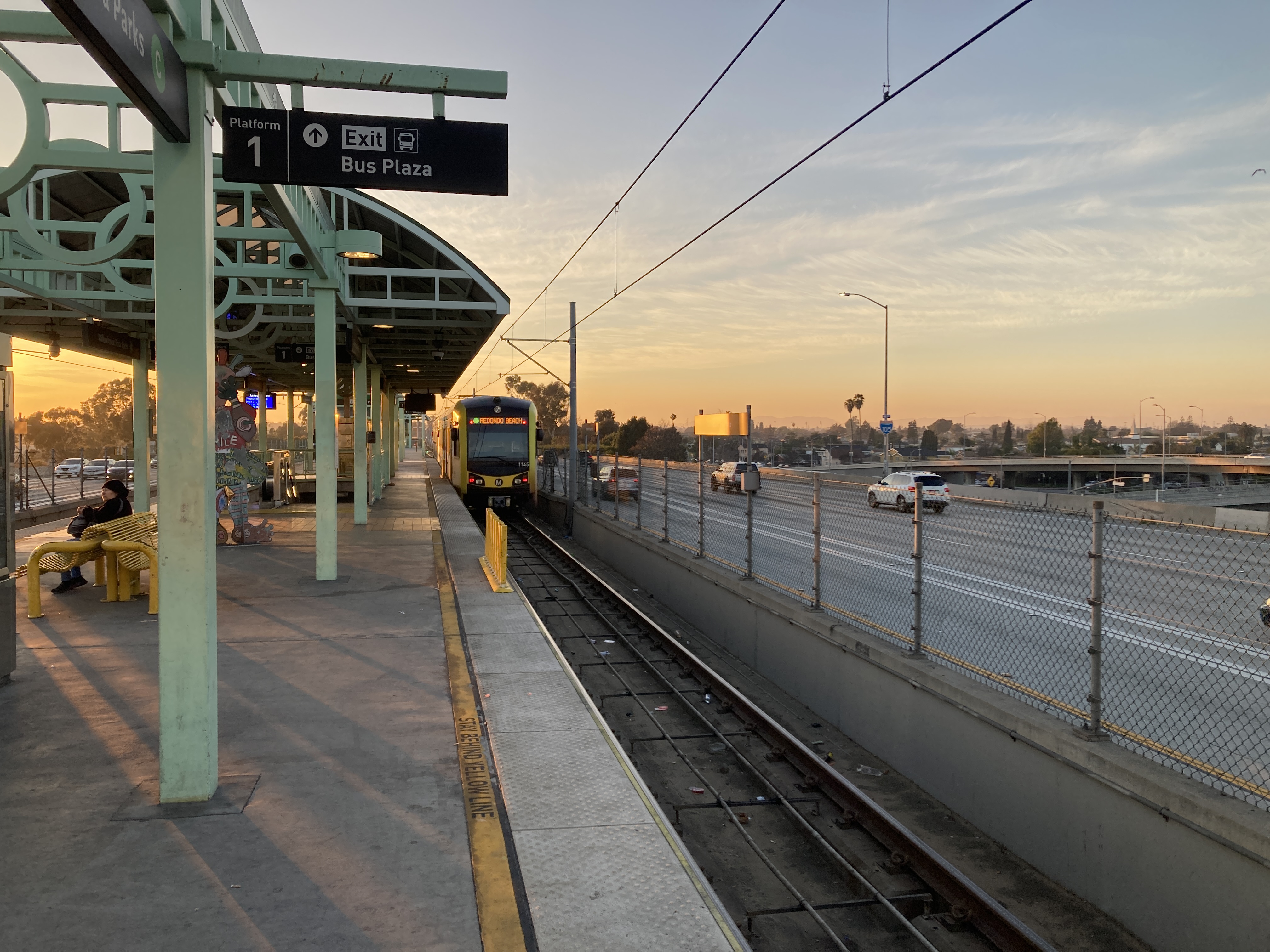 a westbound green line train departs into the sunset